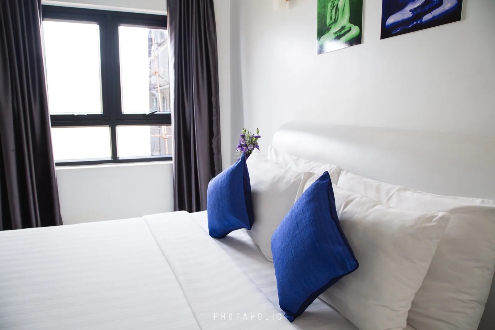 A freshly made bed in a bright room