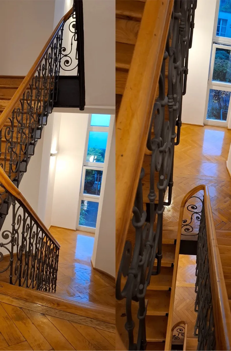 Cleaned stairwell with wooden steps and a wrought-iron railing