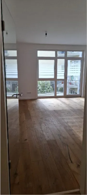 New flat after post-construction cleaning: wooden floor and balcony door clean
